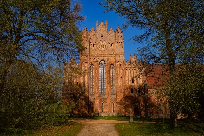 The sunlit main facade of the Chorin Abbey.