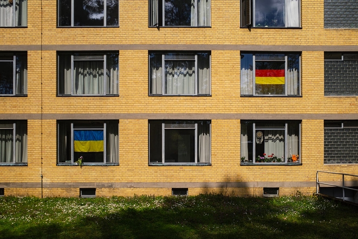 Ukrainian and German flags in the school windows.
