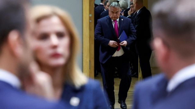 Hungary's Prime Minister Viktor Orban walks as he attends a European Union leaders summit, in Brussels, Belgium December