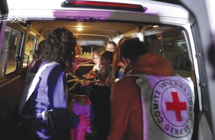  ISRAELI HOSTAGES Sharon Aloni Cunio and twin daughters Yuli and Emma, who were abducted by Hamas in the October 7 attack on Israel, are handed over to the International Committee of the Red Cross, in Gaza, on November 27. (photo credit: HAMAS/REUTERS)