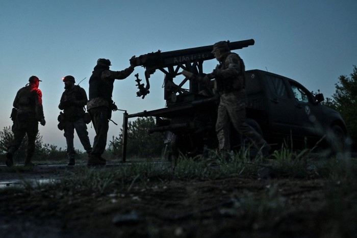 A pro-Ukraine group prepares a rocket launcher to fire towards Russian troops in the Zaporizhzhia region