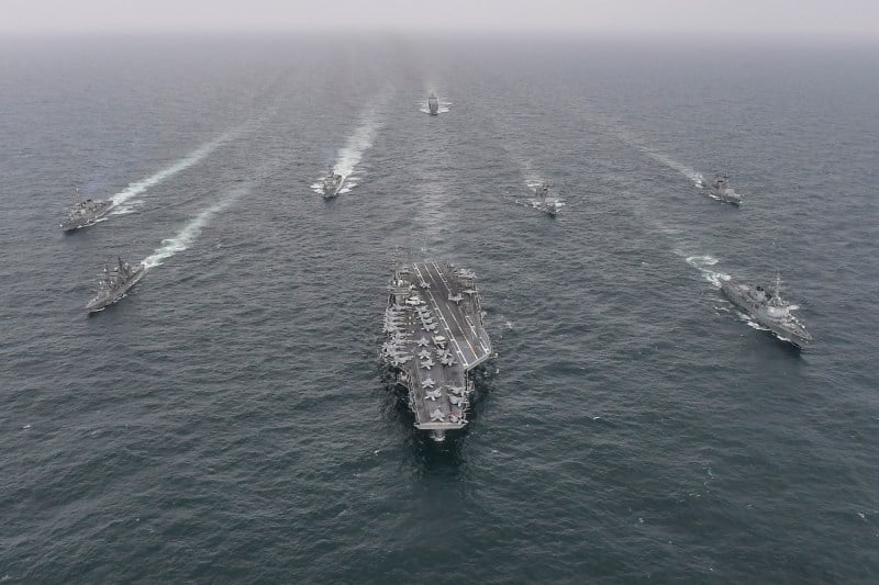 In this handout image released by the South Korean Defense Ministry, South Korean Navy's destroyer Yulgok Yi I (R) U.S. Navy's aircraft carrier USS Nimitz (C) and Japan Maritime Self-Defense Force's Umigiri, (L) sail in formation during a joint naval exercise in international waters off South Korea's southern island of Jeju on Apr. 4, 2023