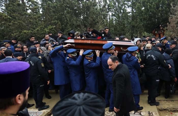 Pilots carry a coffin on Sunday during a funeral in Azerbaijan for crew members of the crashed plane.