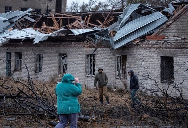 Residents walk at a site of a Russian missile strike, amid Russia’s attack on Ukraine, in Dnipro, Ukraine, on 21 November 2024. (Mykola Synelnykov/Reuters)