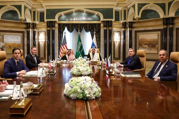 Six men seated around a conference table.