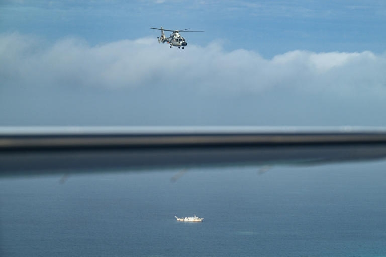 Aircraft indentified as a Chinese navy helicopter conducting aerial reconnaissance over the South China Sea.