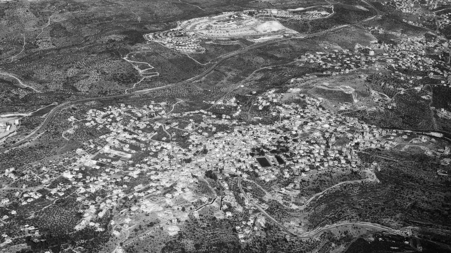 A Palestinian village neighbors an Israeli settlement in the West Bank.