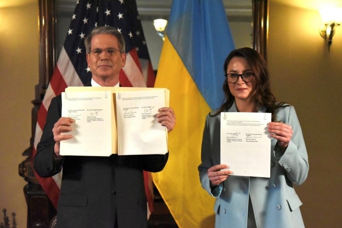US Treasury secretary Scott Bessent and Ukrainian First Deputy Prime Minister Yulia Svyrydenko pose after signing a deal