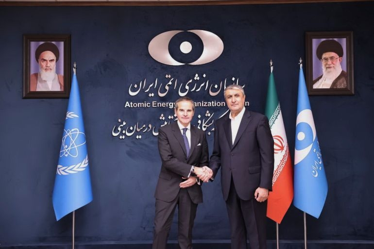In this photo released by the Atomic Energy Organisation of Iran, International Atomic Energy Agency (IAEA) Director General, Rafael Mariano Grossi, left, shakes hands with head of the Atomic Energy Organization of Iran Mohammad Eslami, at the Atomic Energy Organisation of Iran, in Tehran, Iran, Thursday, April 17, 2025. (Atomic Energy Organisation of Iran via AP)