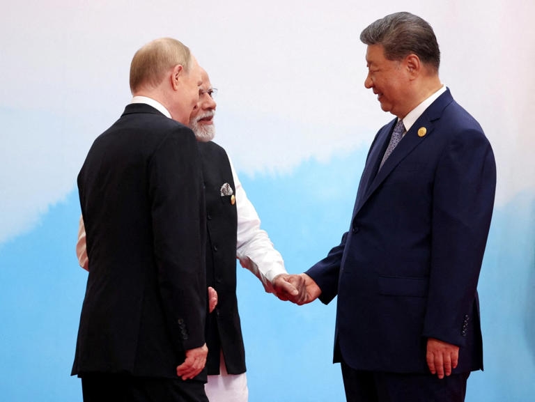 Chinese President Xi Jinping, Indian Prime Minister Narendra Modi, in white, and Russian President Vladimir Putin at the Shanghai Cooperation Organization summit in Tianjin, China, on Monday.