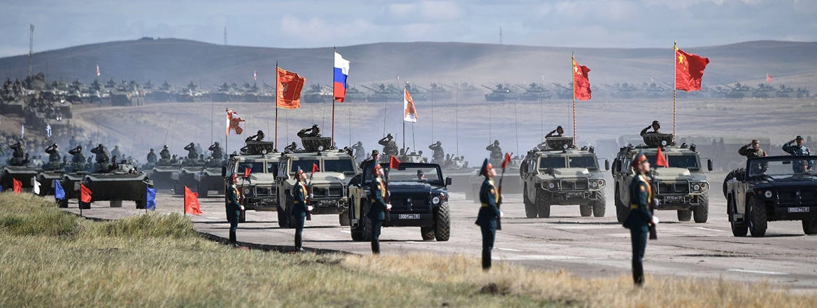Russian and Chinese flags fly during a field review of troops after Exercise Vostok-2018.