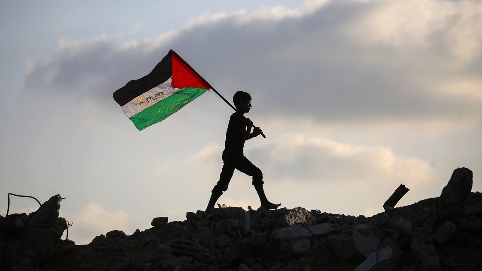 Boy holding Palestinian flag