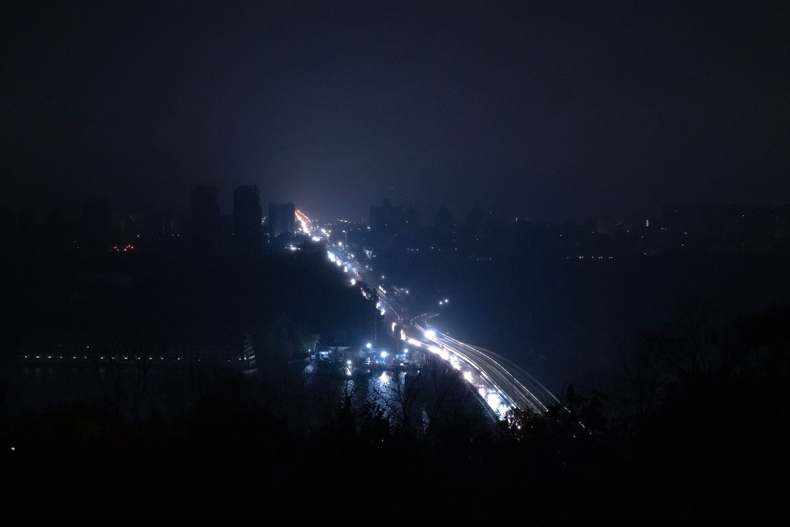Vehicle lights illuminate a highway during a blackout following an emergency power cut in Kyiv, Ukraine, on Oct. 10, 2025.
