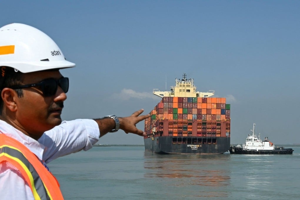 An employee gestures as a container ship departs from Mundra Port in Gujarat state, India’s largest commercial and private port, on November 5. Photo: AFP