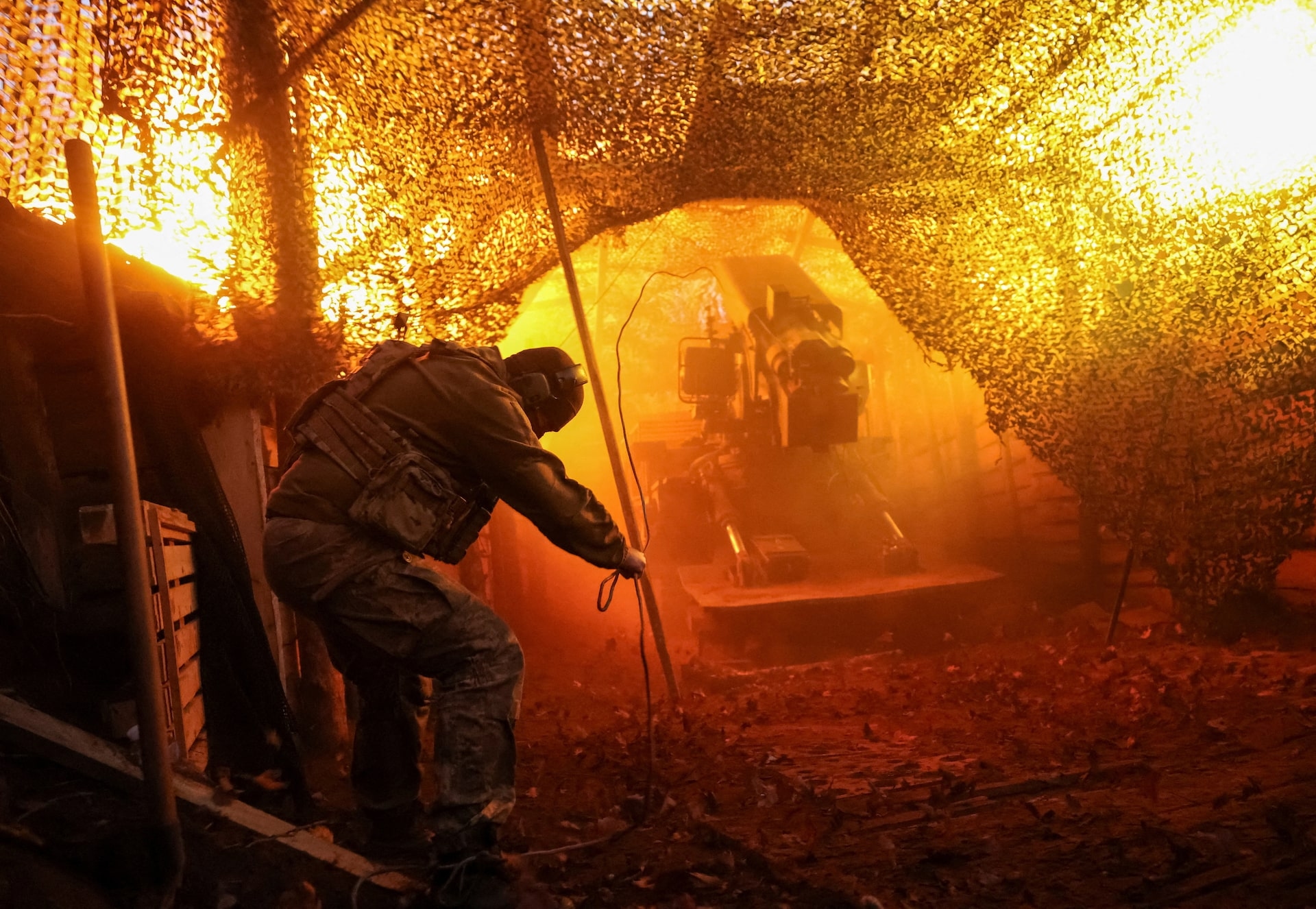 Ukrainian serviceman fires towards Russian troops from a position on a front line near the frontline town of Kostiantynivka