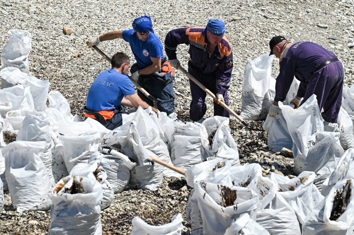 Workers in Tuapse, Russia, cleaning up after a recent drone strike.