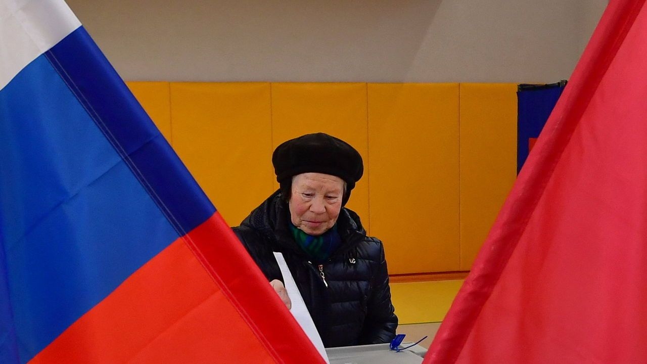 A woman casts her ballot in Russia's presidential election in Saint Petersburg.