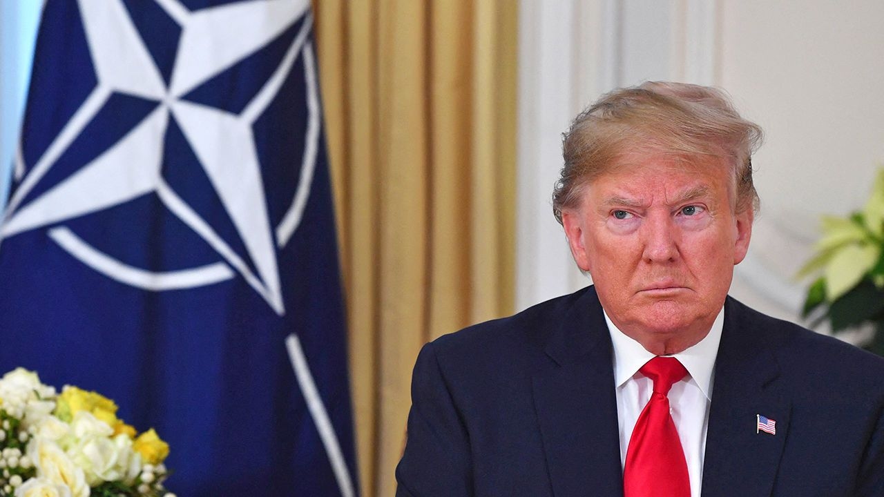 Donald Trump sits next to a NATO flag before a NATO summit in London, UK, December 3rd 2019