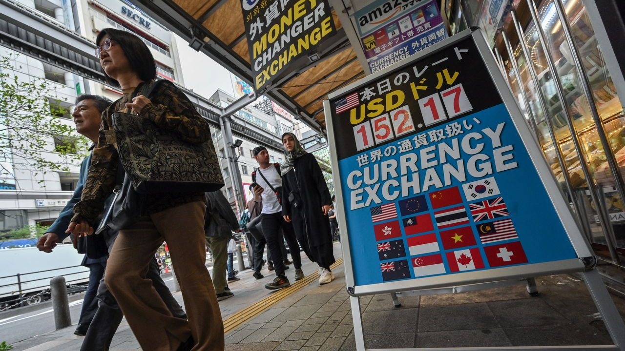 Pedestrians walk past a currency exchange shop in central Tokyo, Japan on April 17th 2024