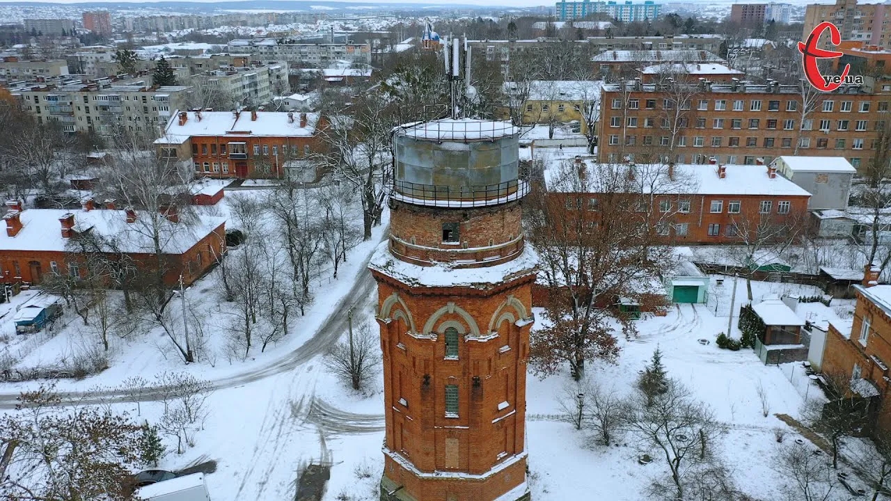May be an image of snow, water tower, tower and text