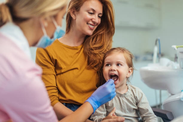 Everything seems perfect Young girl having her dental check up done by a young female dentist family dentist stock pictures, royalty-free photos & images