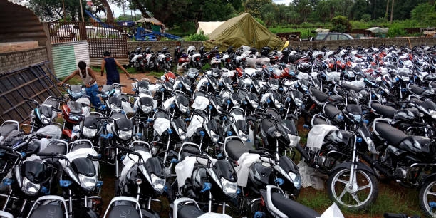 Indian motor bike stock on yard DISTRICT KATNI, INDIA - SEPTEMBER 07, 2019: Bajaj motor bikes kept at open area godown during selling season for festival market. motarbike rent stock pictures, royalty-free photos & images