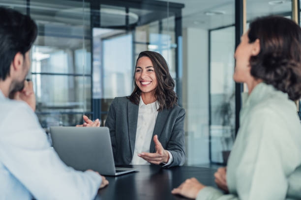Group of business persons talking in the office. Shot of group of business persons in business meeting. Three entrepreneurs on meeting in board room. Corporate business team on meeting in modern office. Female manager discussing new project with her colleagues. Company owner on a meeting with two of her employees in her office. Business Consulting Firms stock pictures, royalty-free photos & images