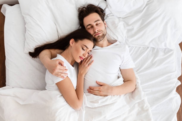 6,100+ Young Couple Sleeping Together In Bed Stock Photos and Royalty-Free  Pictures - iStock